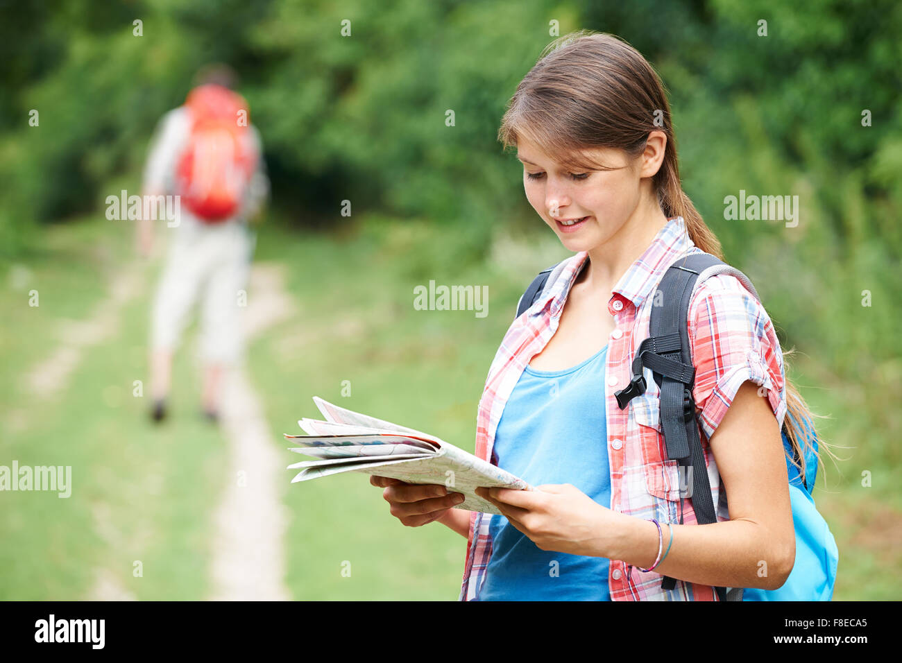 Young Couple Hiking In Countryside Stock Photo