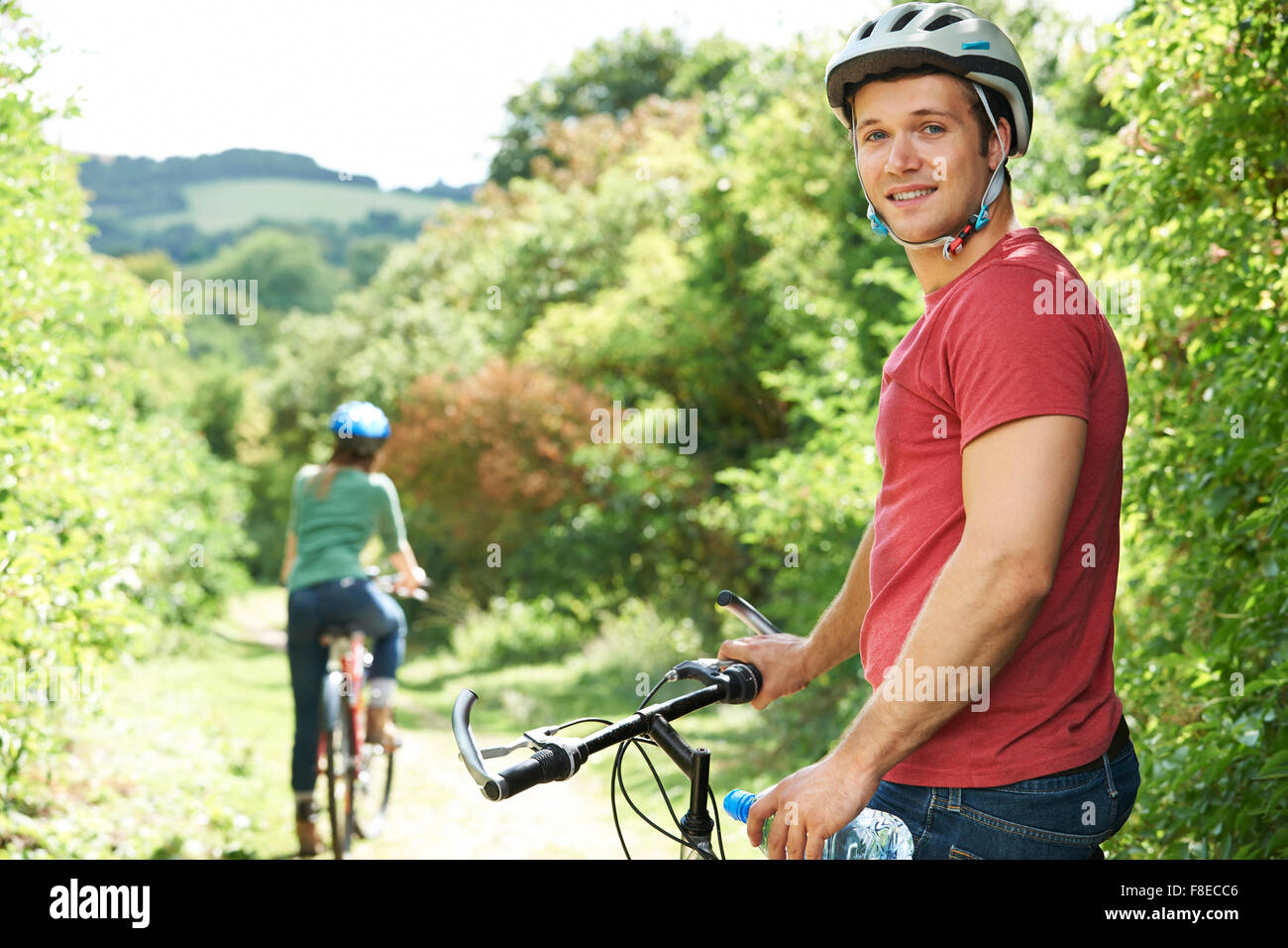 Young Couple Cycling In Countryside Stock Photo