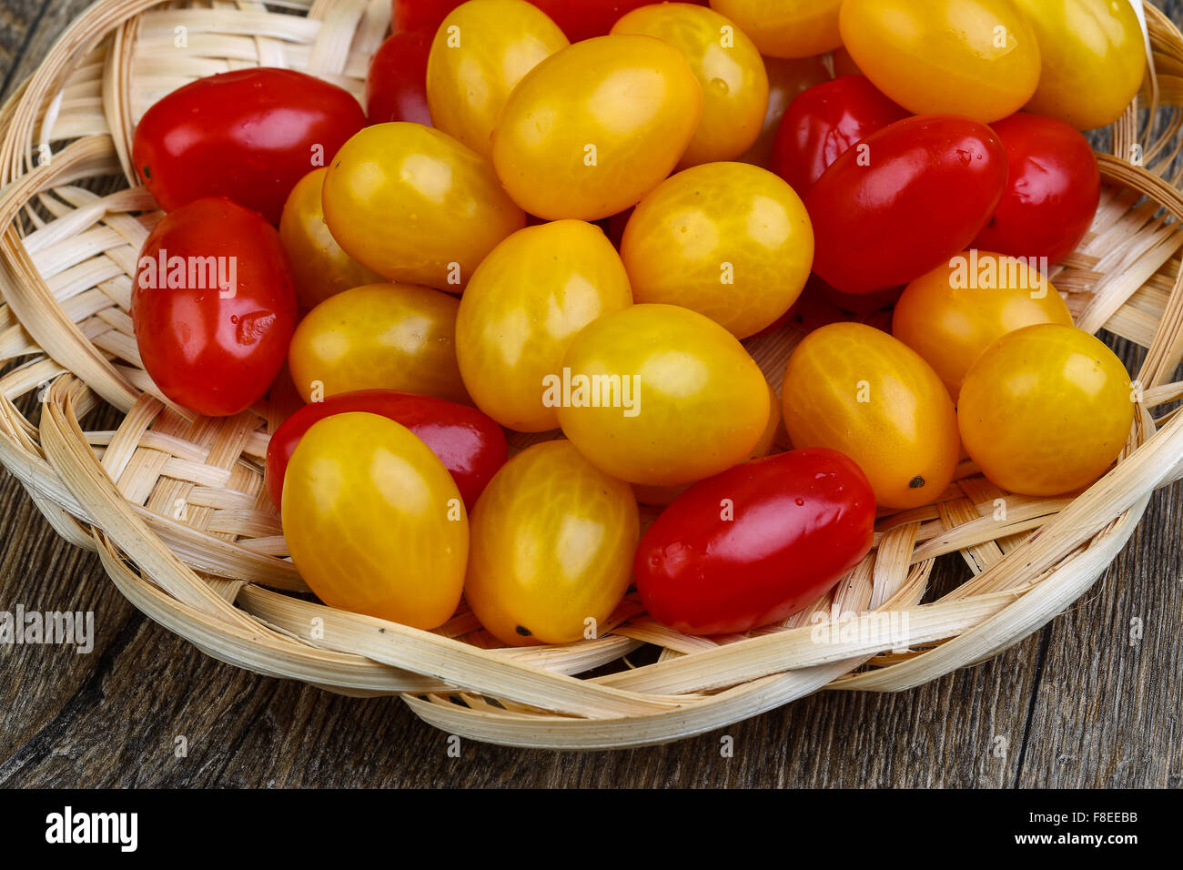 Yellow and red cherry tomatoes mix on the basket Stock Photo - Alamy