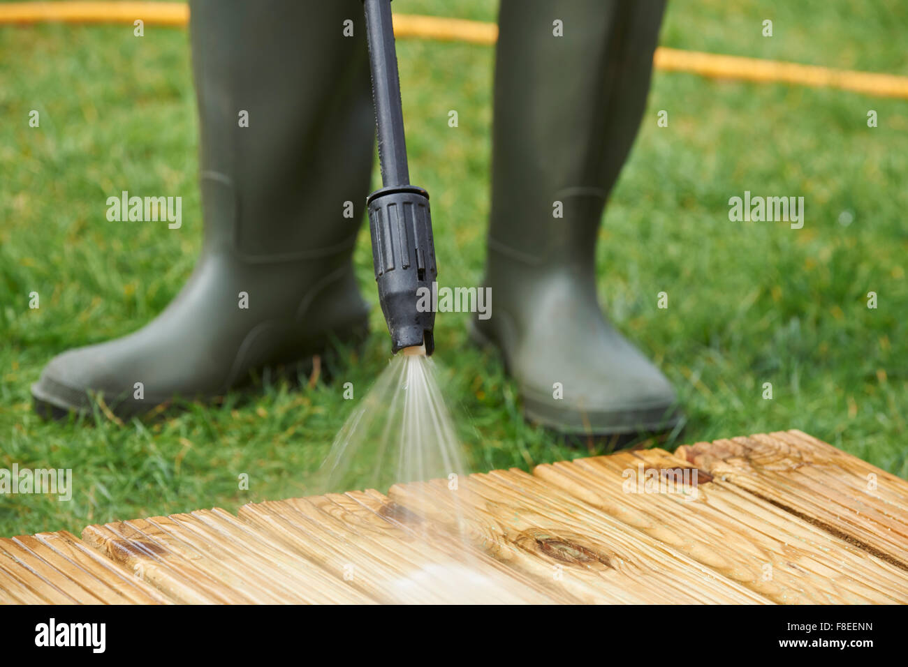 Man Washing Wooden Decking With Pressure Washer Stock Photo Alamy