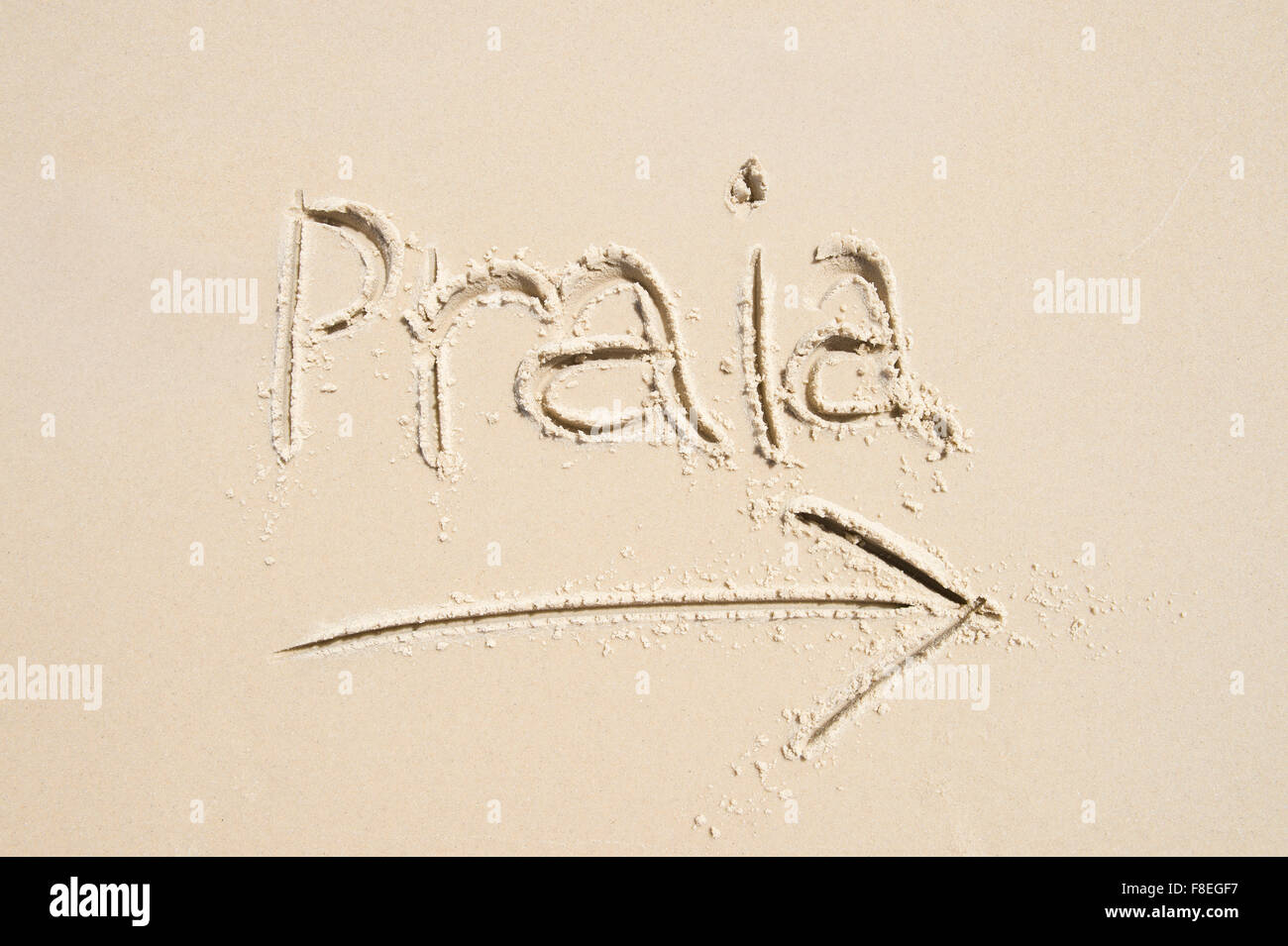 Saudade, Portuguese word meaning nostalgia or longing composed with yellow  colored stone letters over green sand Stock Photo - Alamy