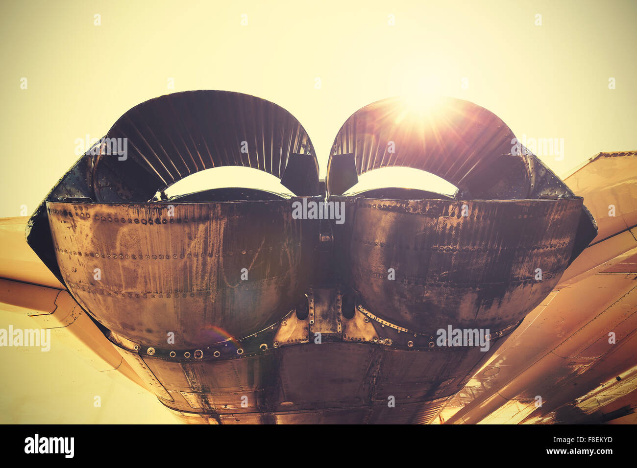 Retro toned jet exhaust pipes against sun. Stock Photo