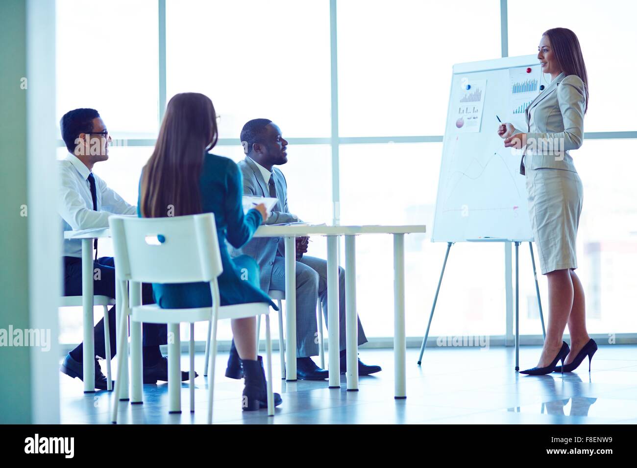 Businesswoman presenting new project to partners Stock Photo