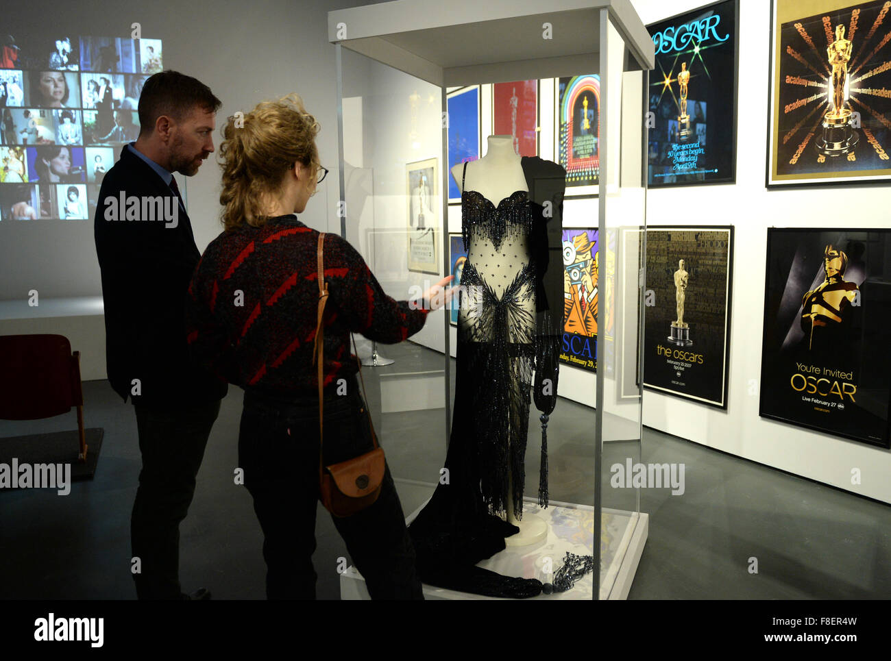 Visitors look at a dress worn by US singer Cher during the 1988 Academy Awards at the exhibition 'Best Actress - Oscars, Roles, and Images' in Berlin, Germany, 09 December 2015. The exhibition can be seen from 10 December 2015 until 01 May 2016 in the   Deutsche Kinemathek. Photo: BRITTA PEDERSEN/dpa Stock Photo
