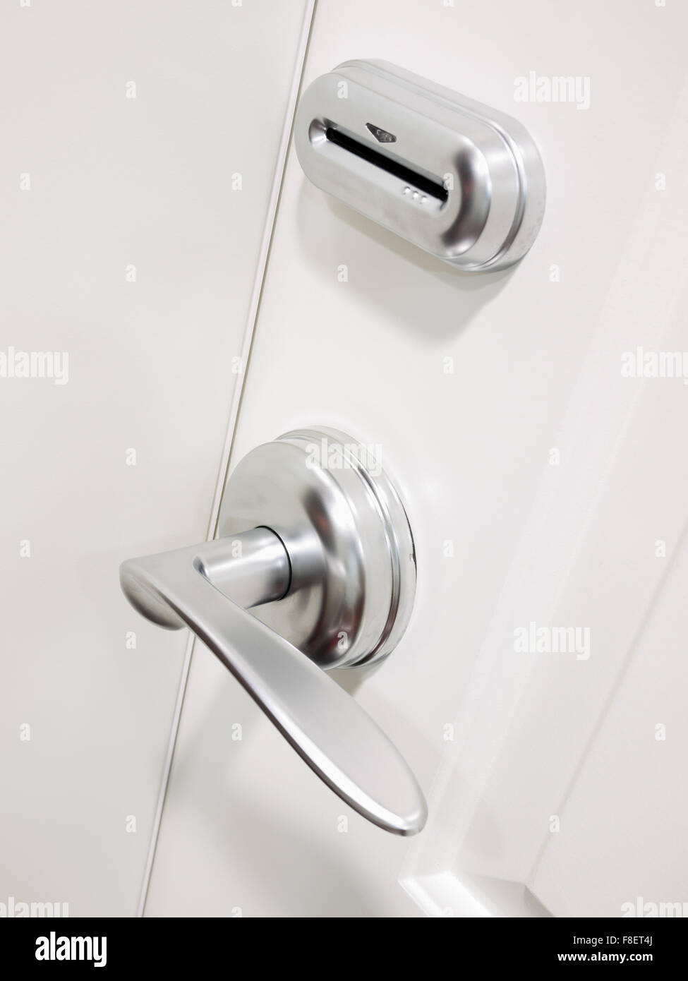 Electronic keycard door lock security system on a hotel room door Stock Photo