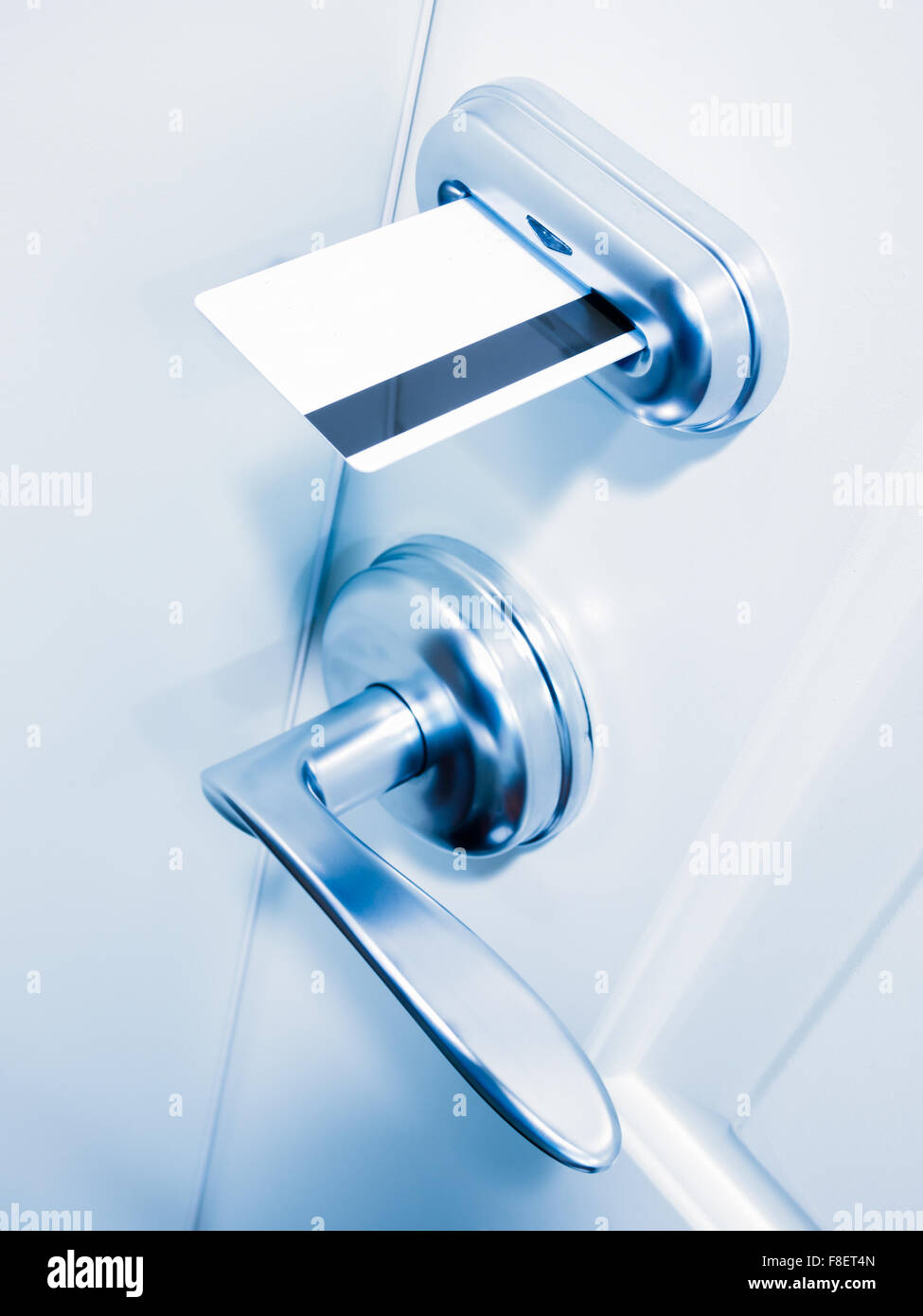 Hotel room keycard door lock with a blue tone Stock Photo