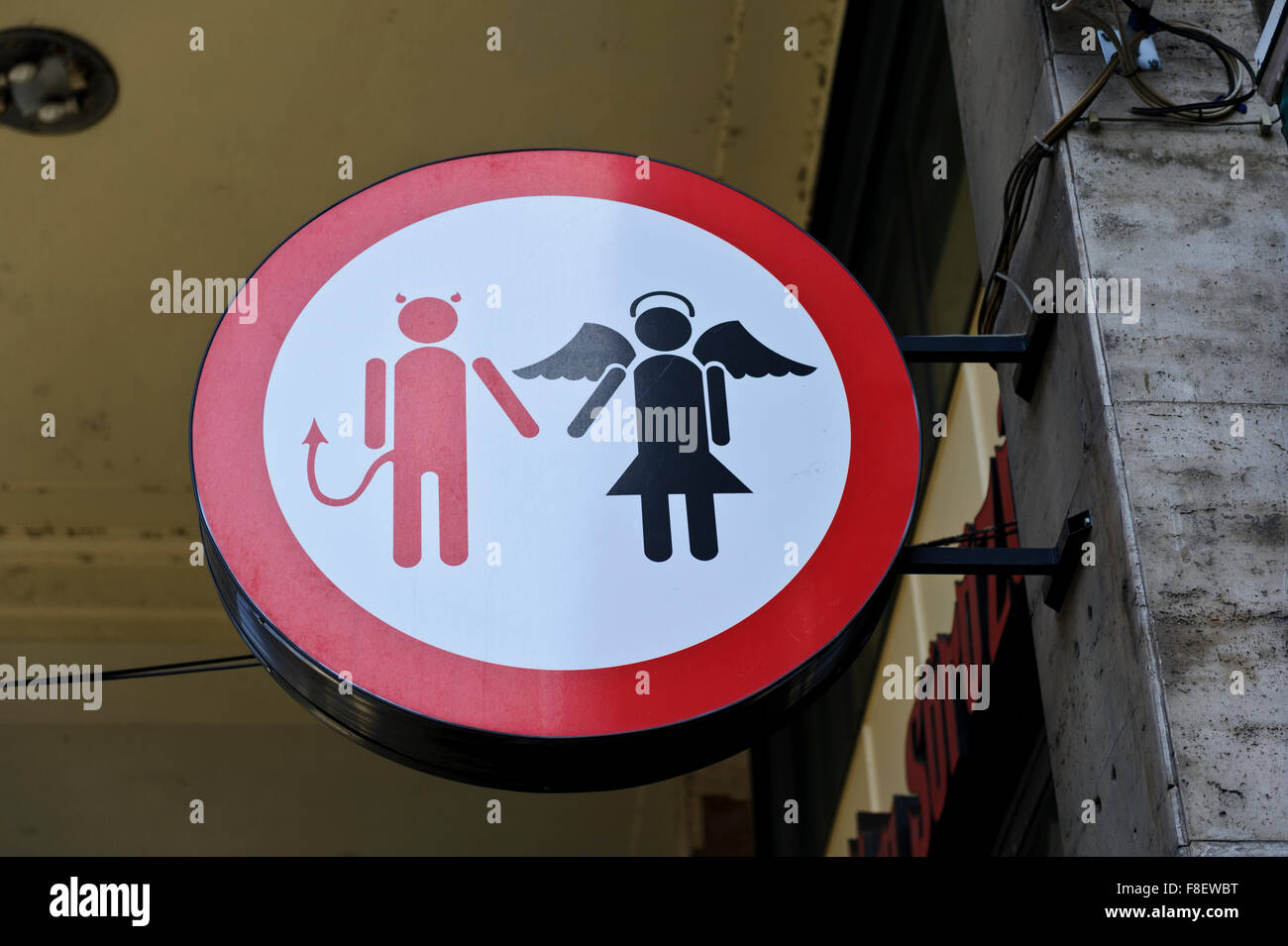 A circular sign with a symbolic figure of a man as a devil and a woman as an angel, Budapest, Hungary. Stock Photo