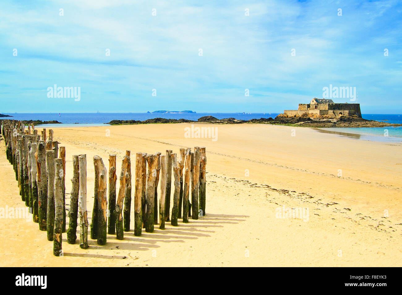 Saint Malo beach, Fort National and wooden poles during Low Tide. Brittany, France, Europe. Stock Photo