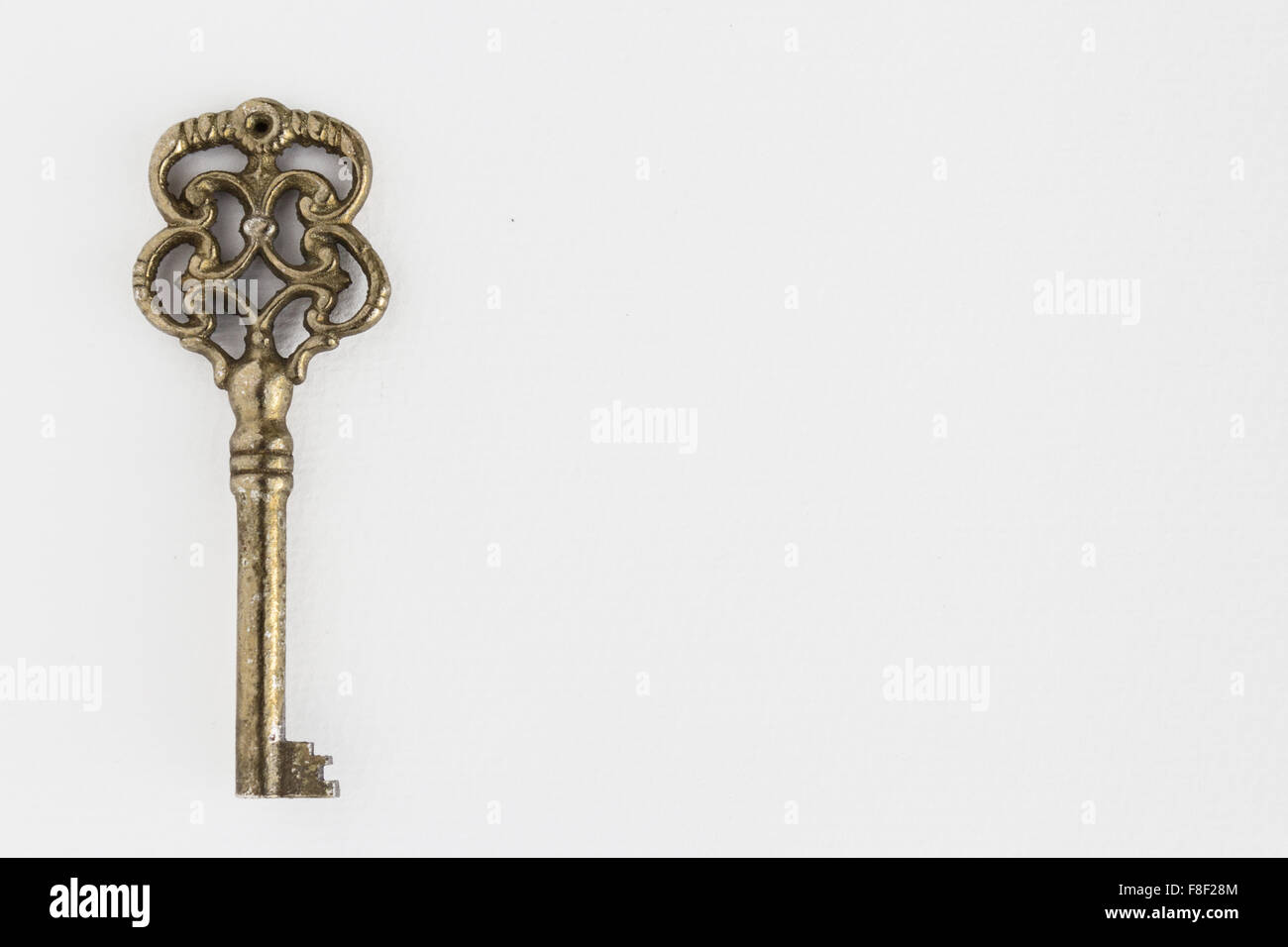 old ornate key on white background with copy space Stock Photo