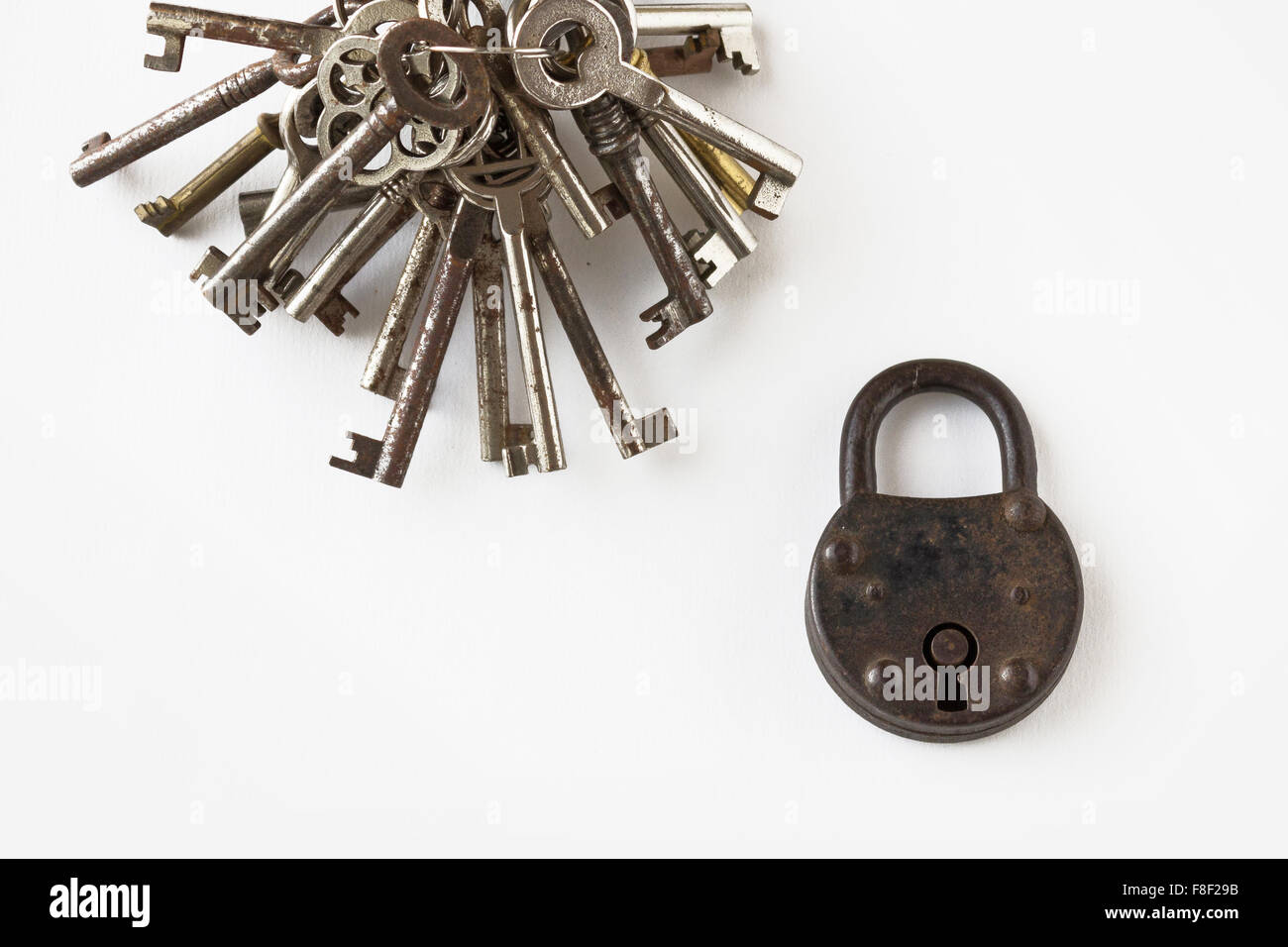 old padlock with bunch of keys on white background Stock Photo - Alamy
