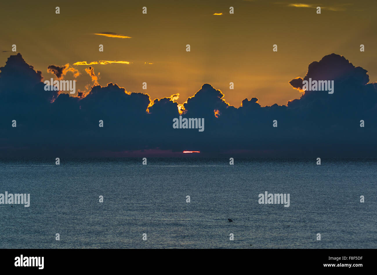 a cloudy sunrise at sea Stock Photo Alamy