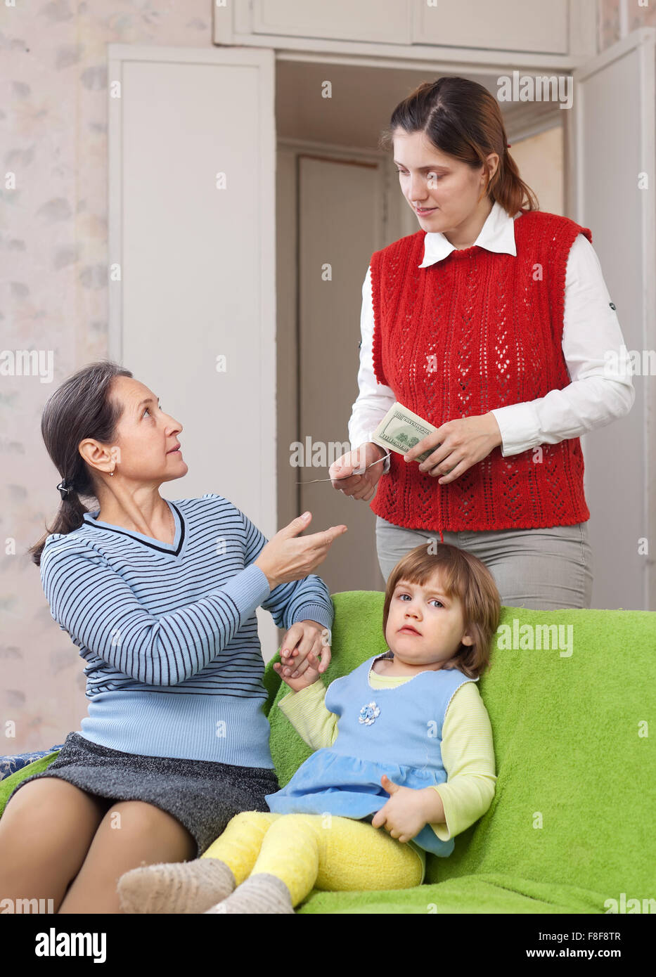 mother leaving baby with babysitter at home Stock Photo