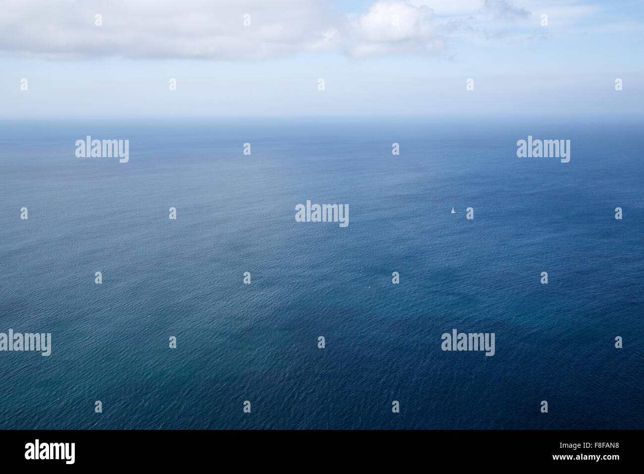 A lone sail boat in the ocean Stock Photo - Alamy