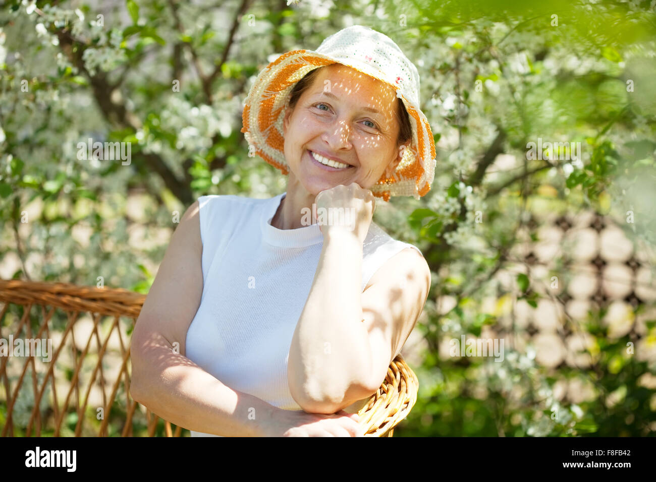 Happy mature woman relaxing in spring garden Stock Photo - Alamy