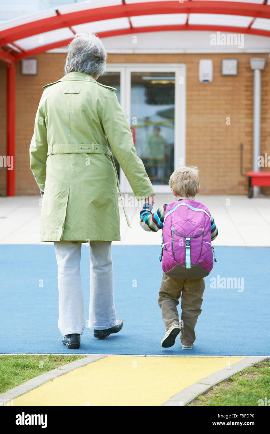 Grandmother Taking Grandson To School Stock Photo