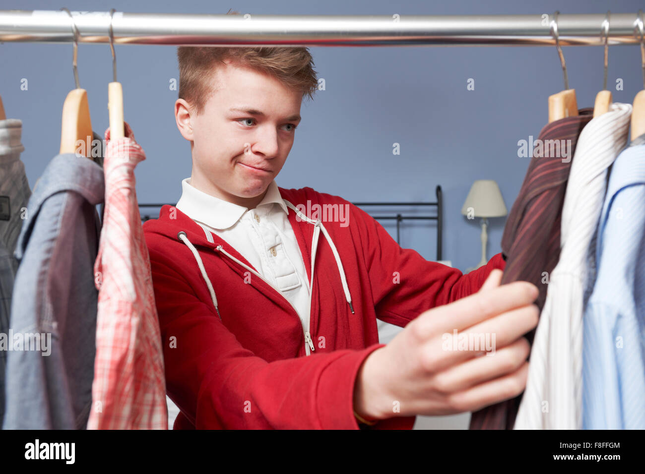 Teenage Boy Choosing Clothes From Wardrobe Stock Photo