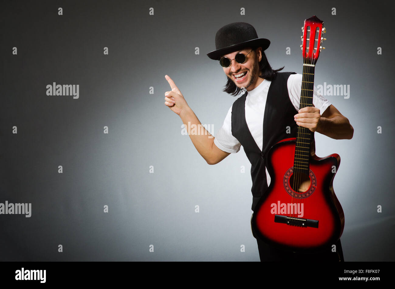 Man wearing sunglasses and playing guitar Stock Photo Alamy