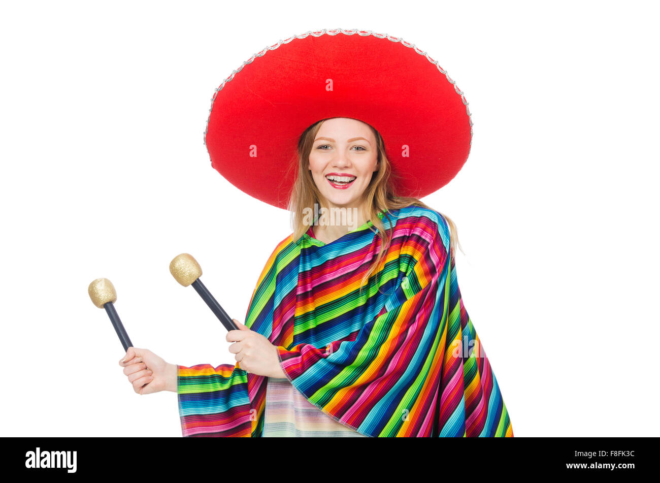Pretty girl in mexican poncho shaking maracas isolated on white Stock