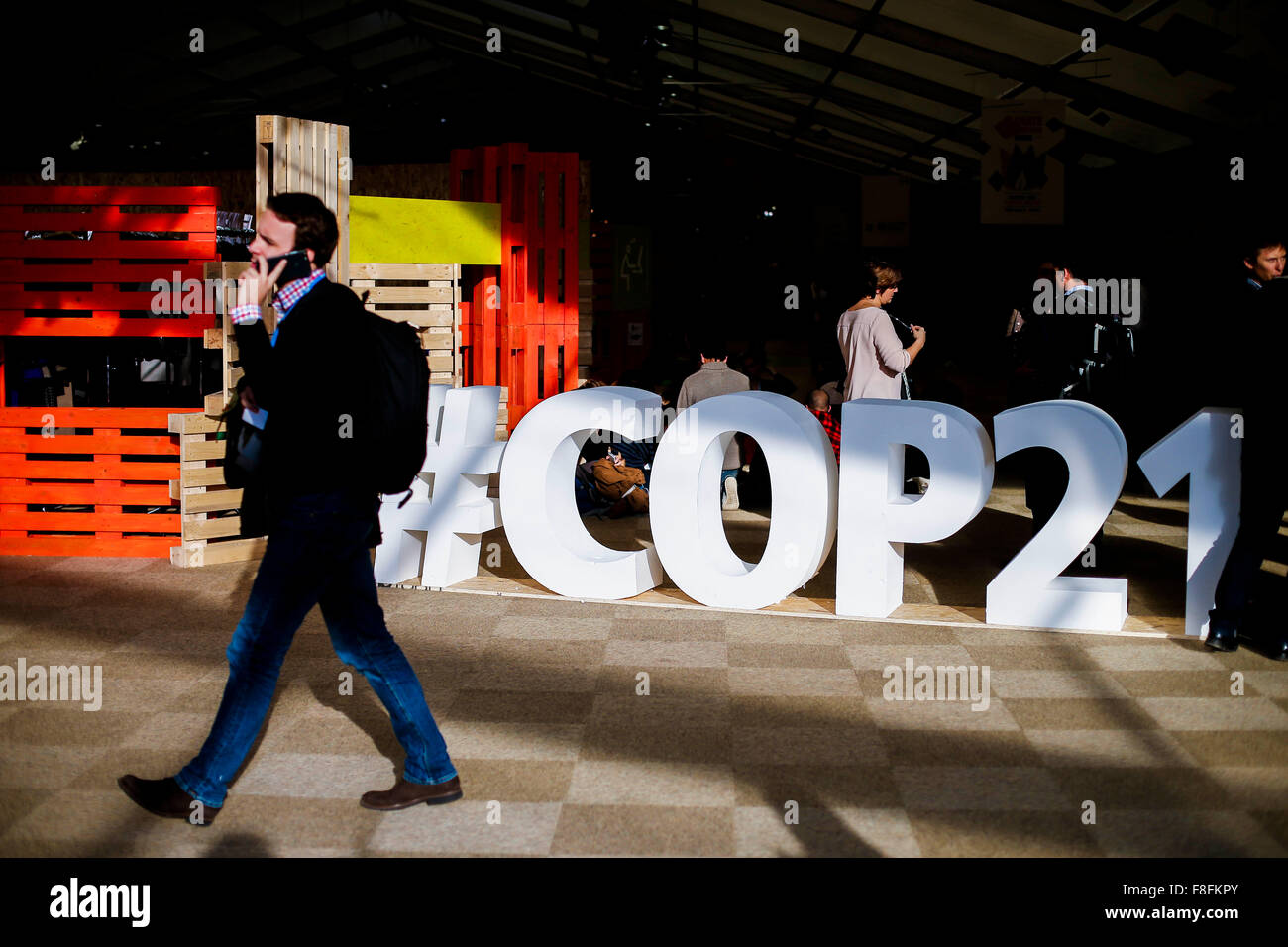 (151209) -- PARIS, Dec. 9, 2015 (Xinhua) -- Participants walk at the venue of Paris Climate Change Conference at Le Bourget on the northern suburbs of Paris, France, Dec. 9, 2015. French Foreign Minister and President of Paris Climate Conference Laurent Fabius presented a new clean version of text for a global climate agreement on Wednesday as a basis for further negotiations among countries in the next 48 hours. The main outstanding issues that remain to be resolved include post-2020 climate finance, ambition of action and how to reflect the principle of 'common but differentiated responsibil Stock Photo