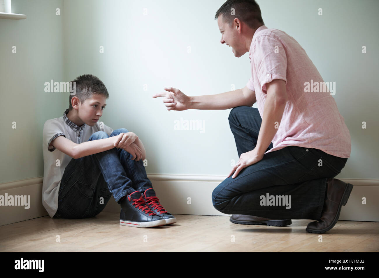 Father Being Physically Abusive Towards Son Stock Photo
