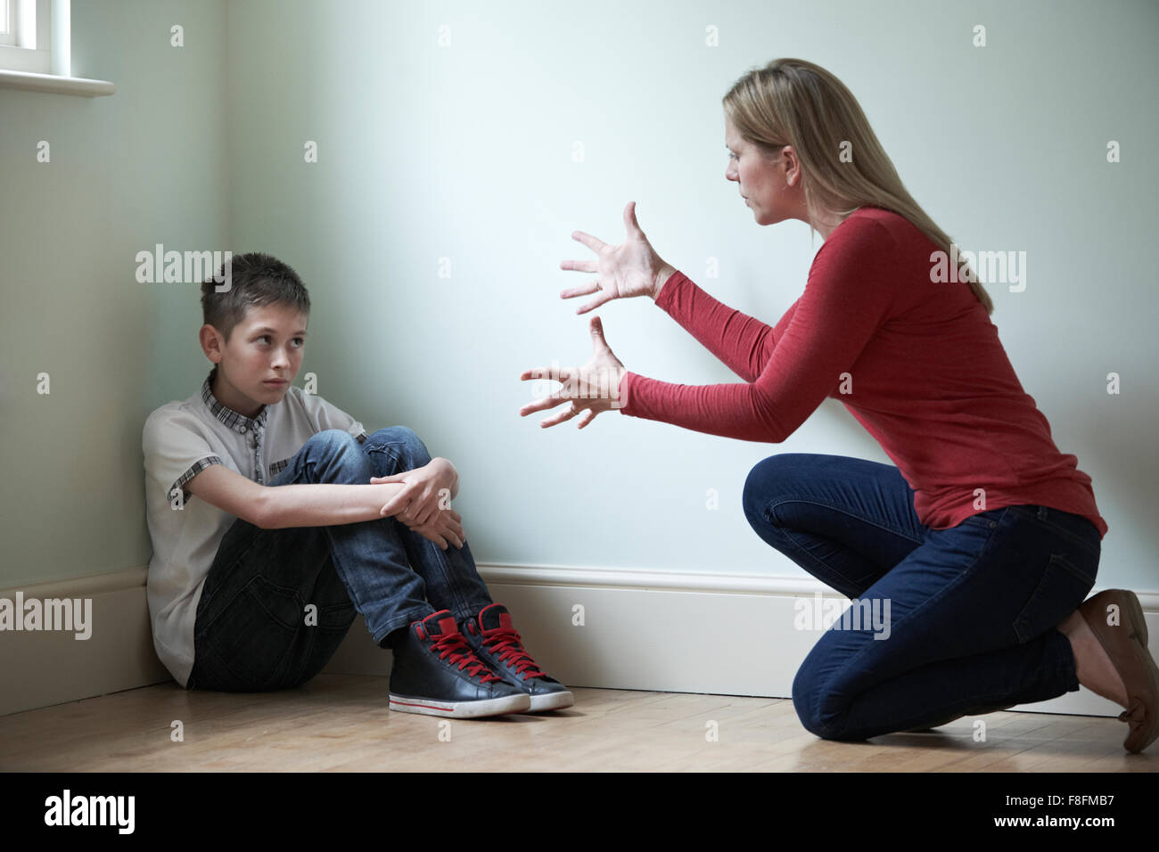 Mother Being Physically Abusive Towards Son Stock Photo