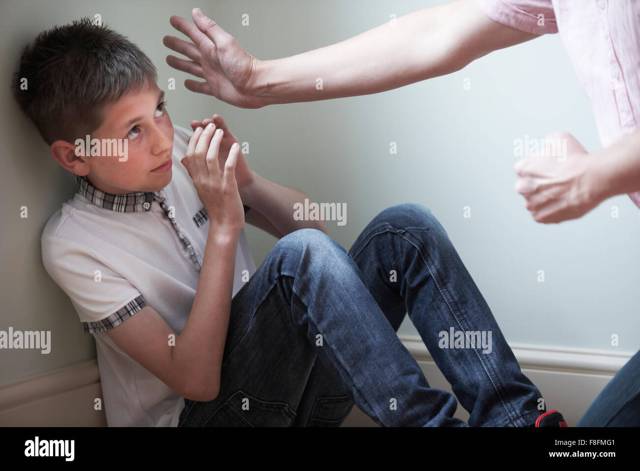 Father Being Physically Abusive Towards Son Stock Photo