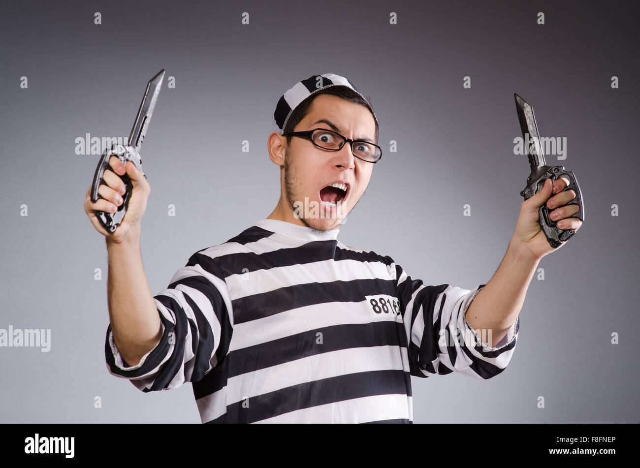 Funny prisoner with knuckles isolated on gray Stock Photo Alamy