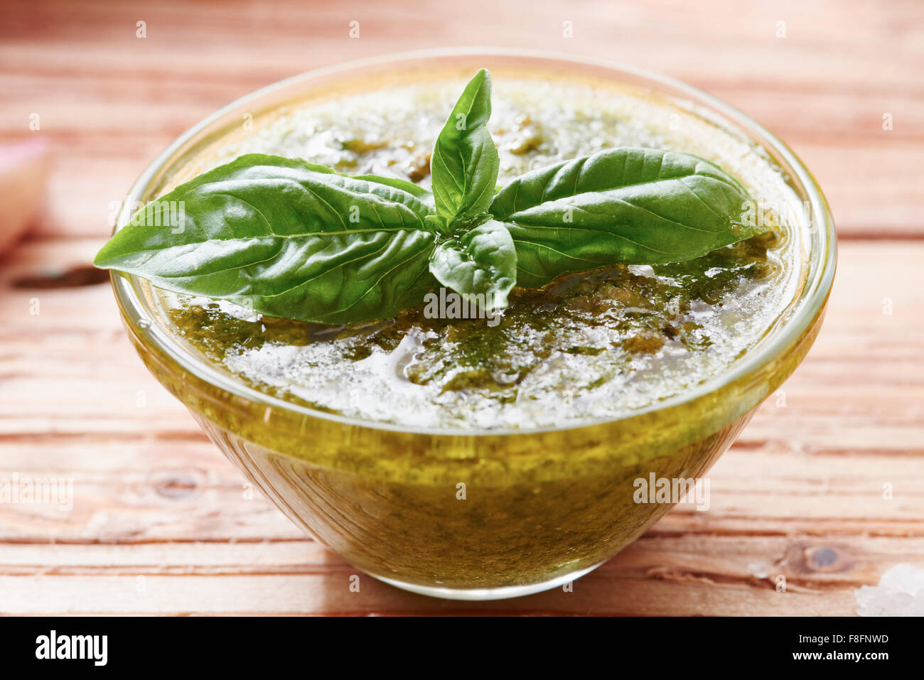 Pesto sauce on wooden table surrounded by ingredients Stock Photo