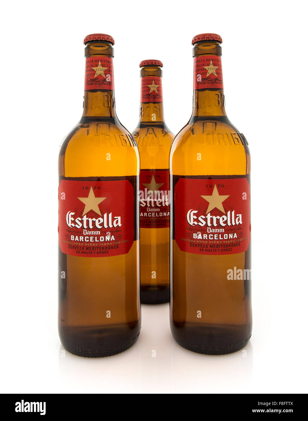 Three Bottles of Estrella Damm beer on on a White Background Stock Photo