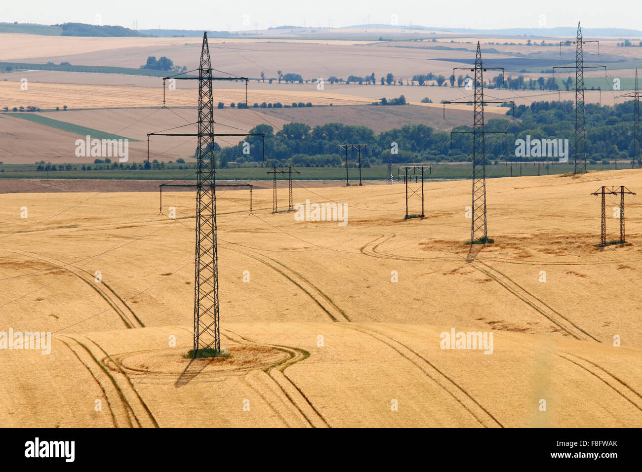 Pylons in the fields - energy distribution Stock Photo