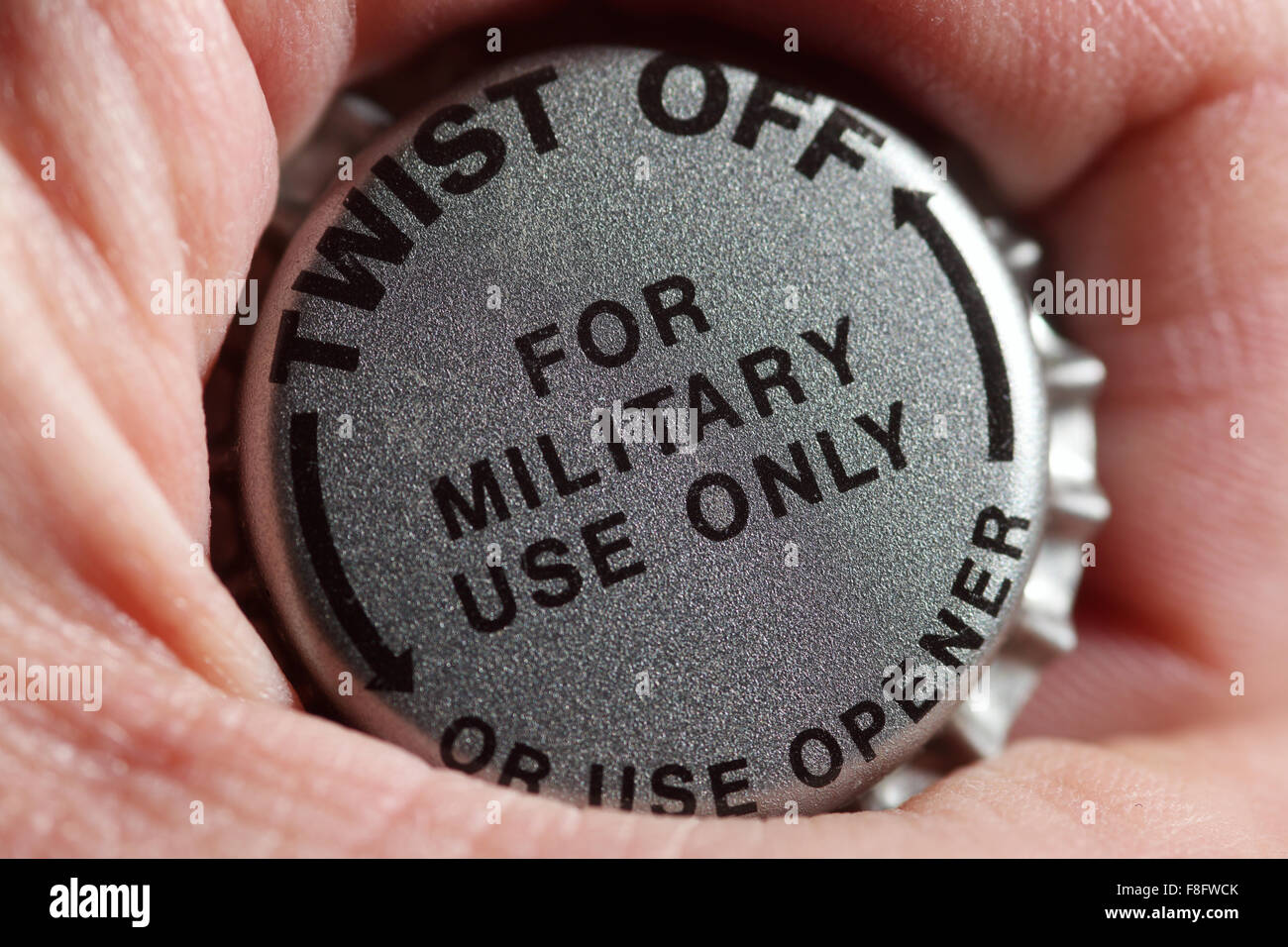 twist off beer cap in fist Stock Photo Alamy