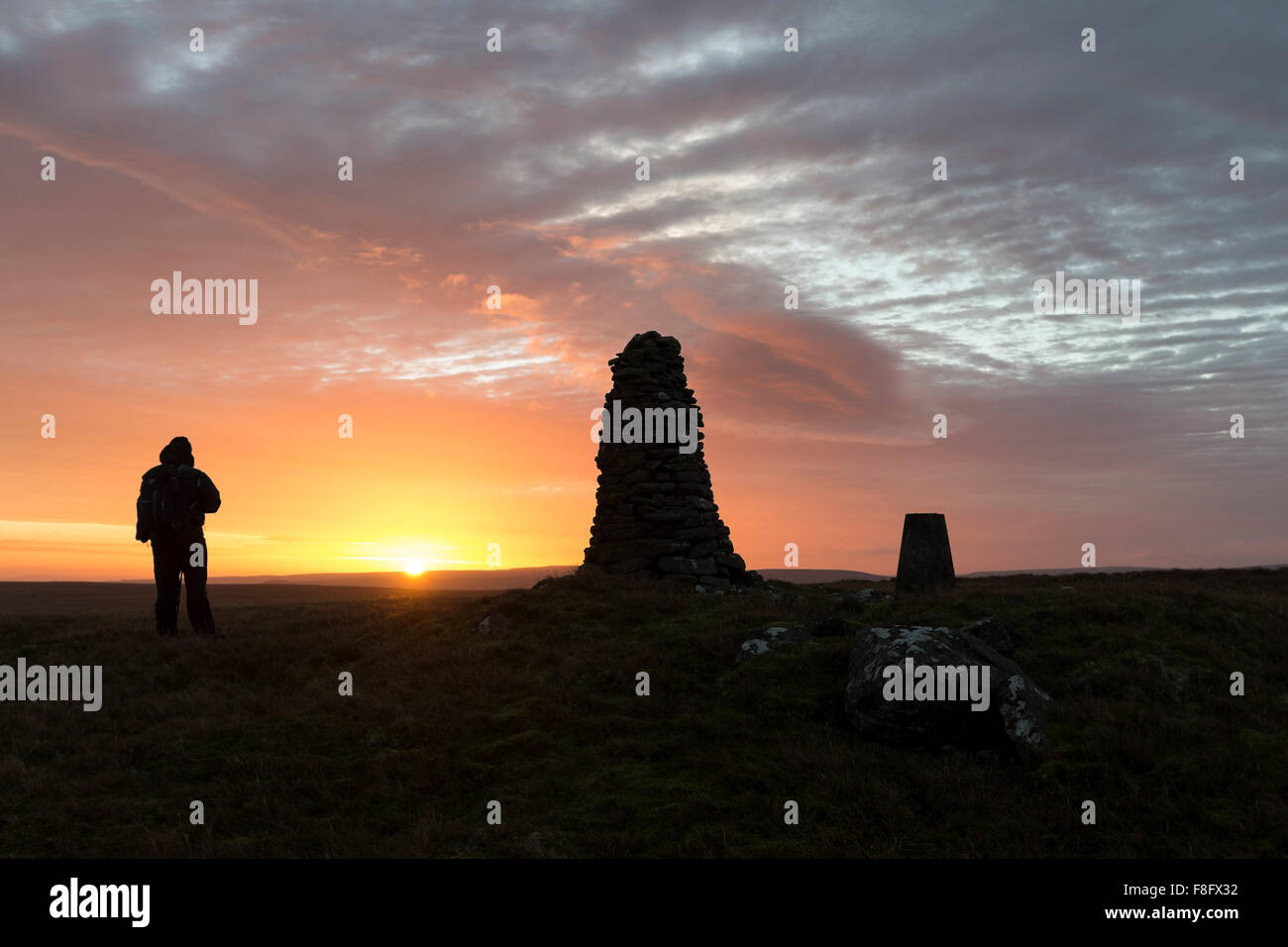 Walker Enjoying the Sunrise on the Summit of Shacklesborough Baldersdale Teesdale County Durham UK Stock Photo