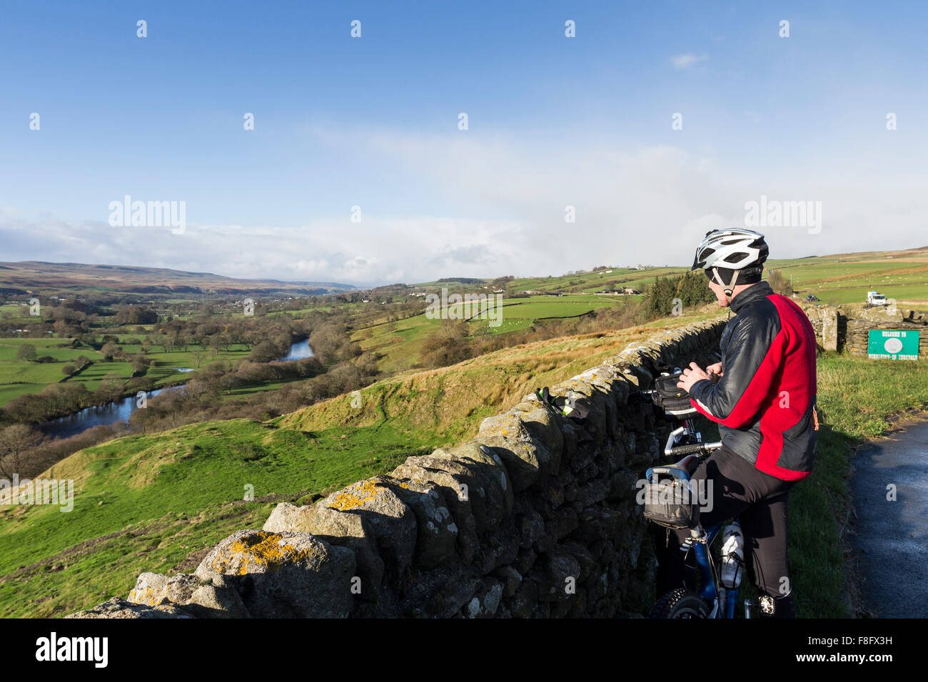 Cyclist Enjoying the View from Whistle Crag Teesdale County Durham UK Stock Photo