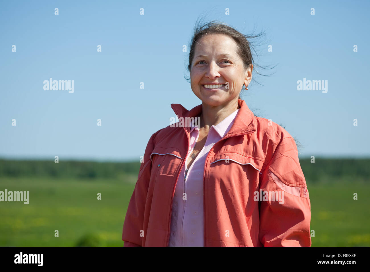 Outdoor portrait of smiling mature woman Stock Photo - Alamy