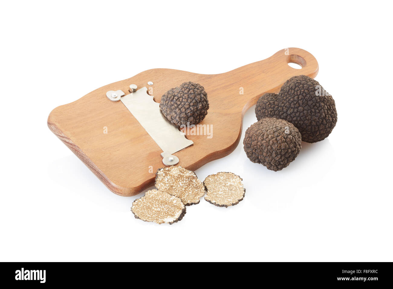 Black truffles, slices and wooden truffle slicer on white Stock Photo