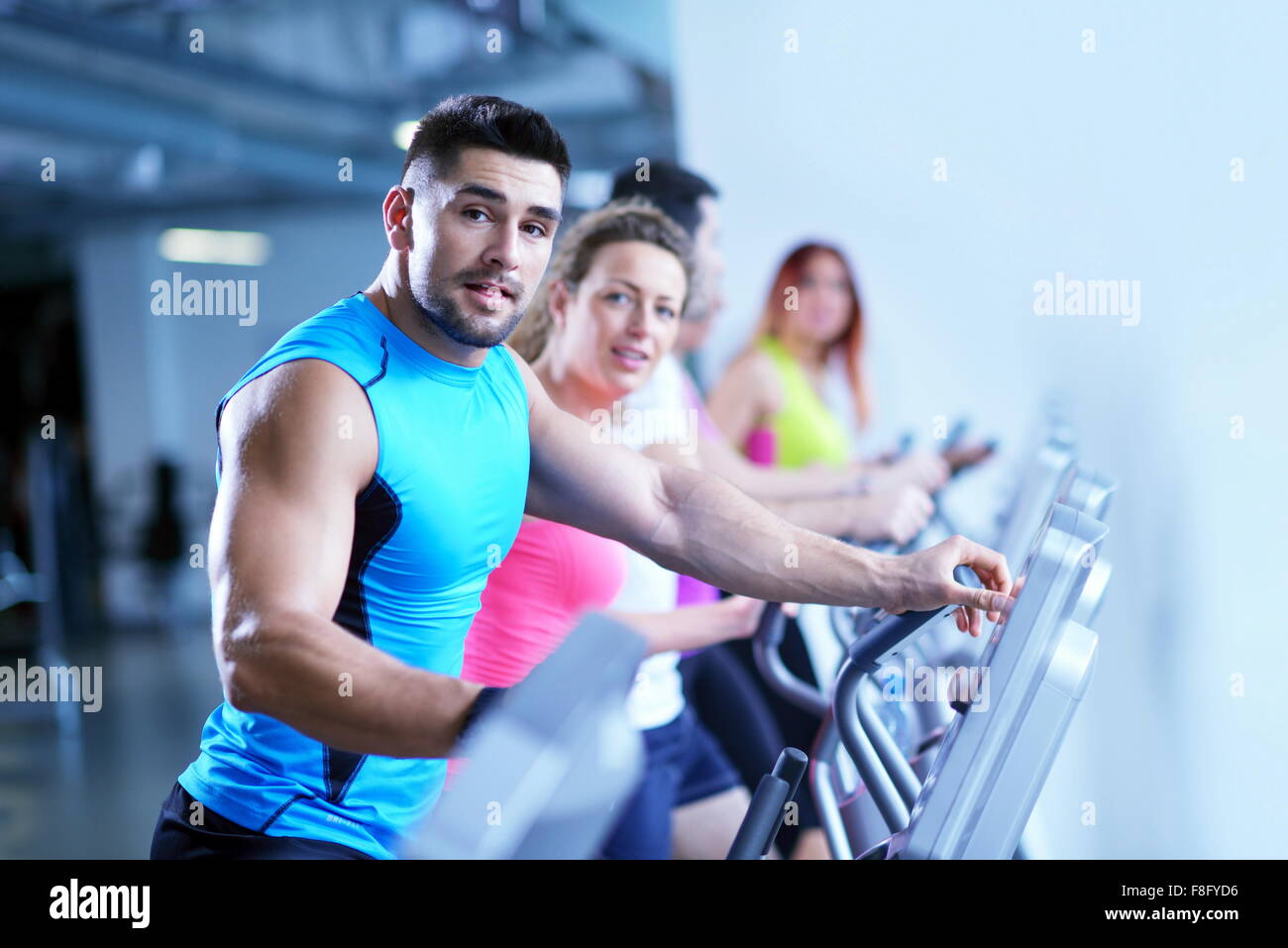 group of young people running on treadmills in modern sport gym Stock ...