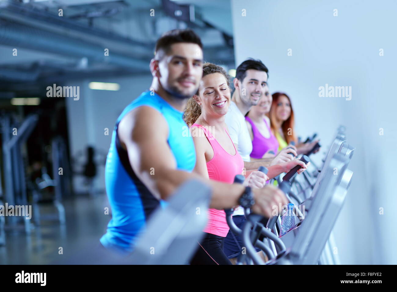group of young people running on treadmills in modern sport gym Stock ...