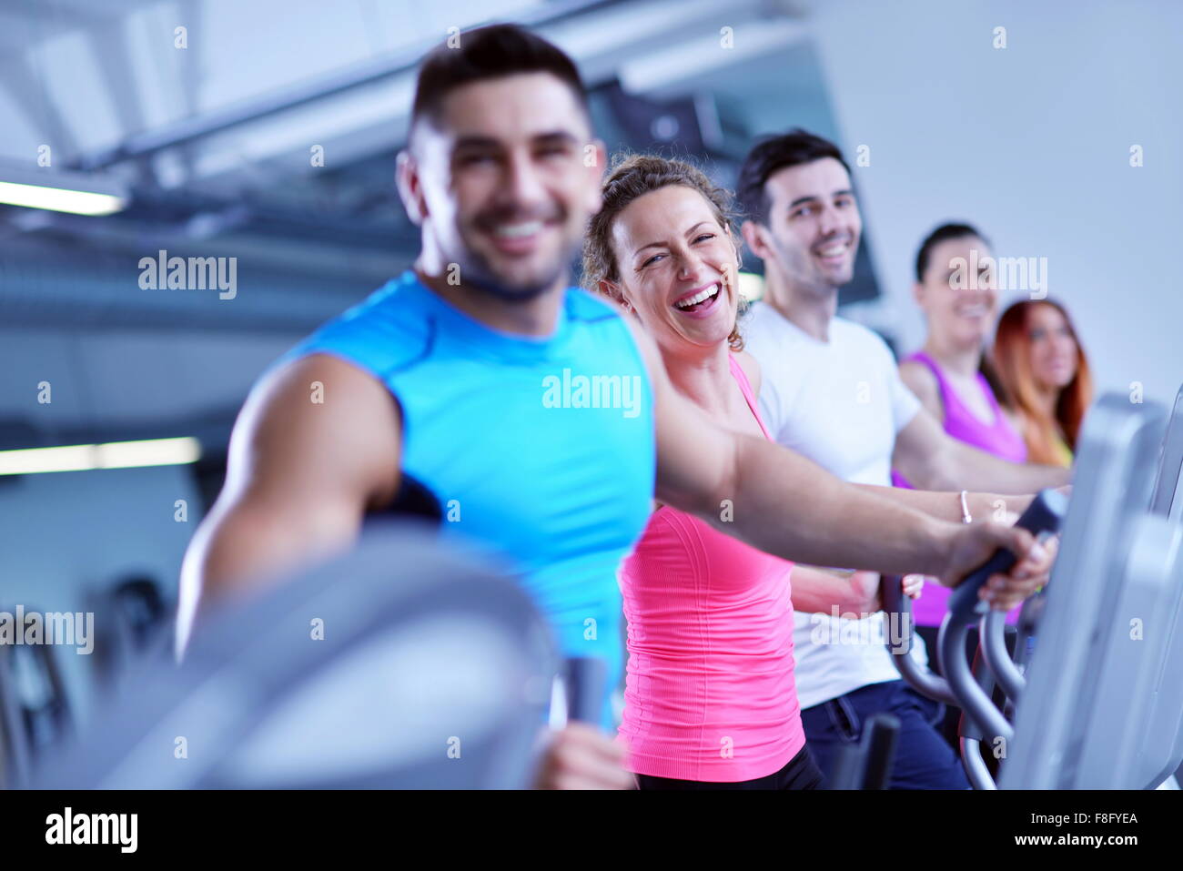 group of young people running on treadmills in modern sport gym Stock ...