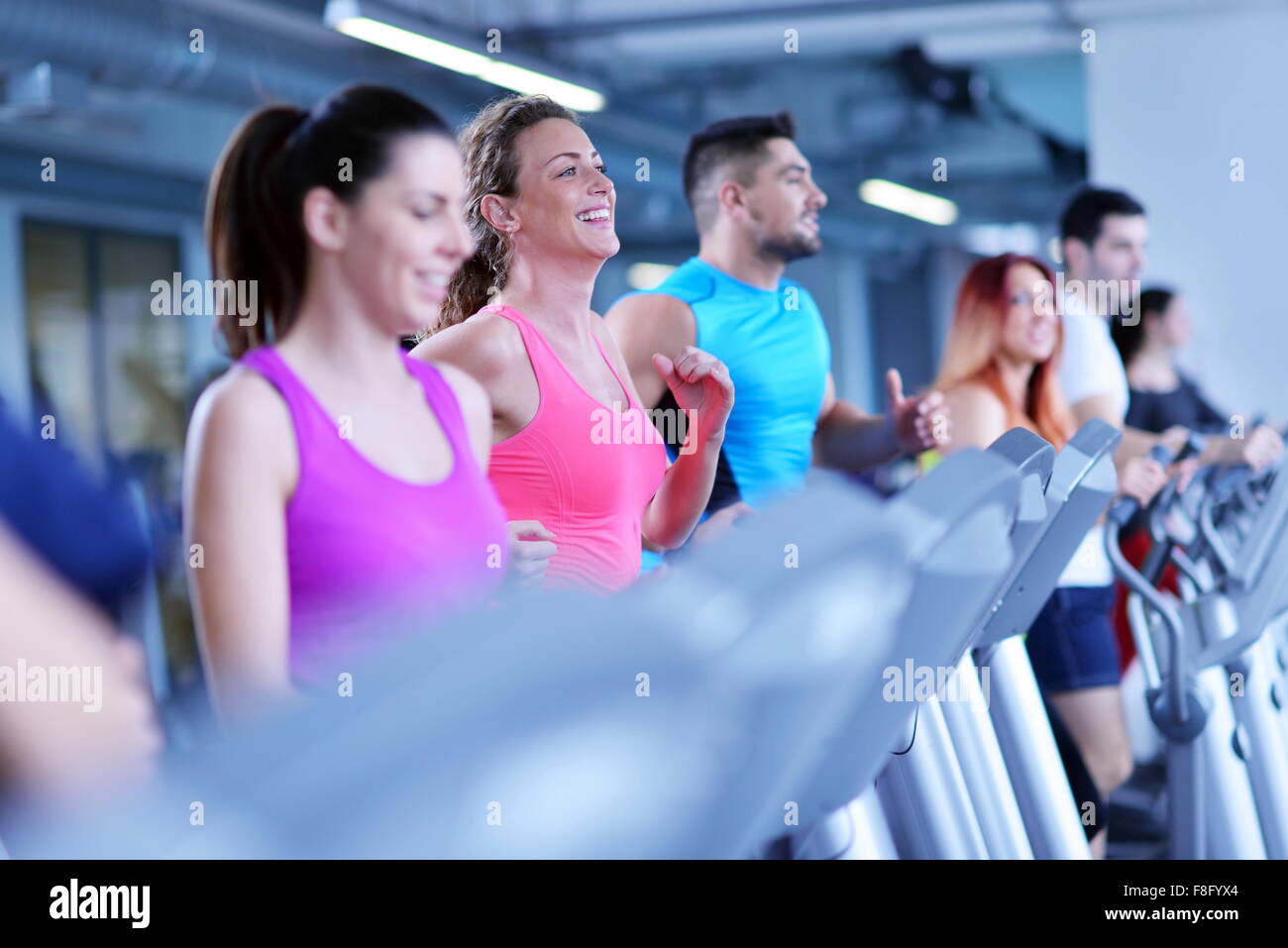 group of young people running on treadmills in modern sport gym Stock ...