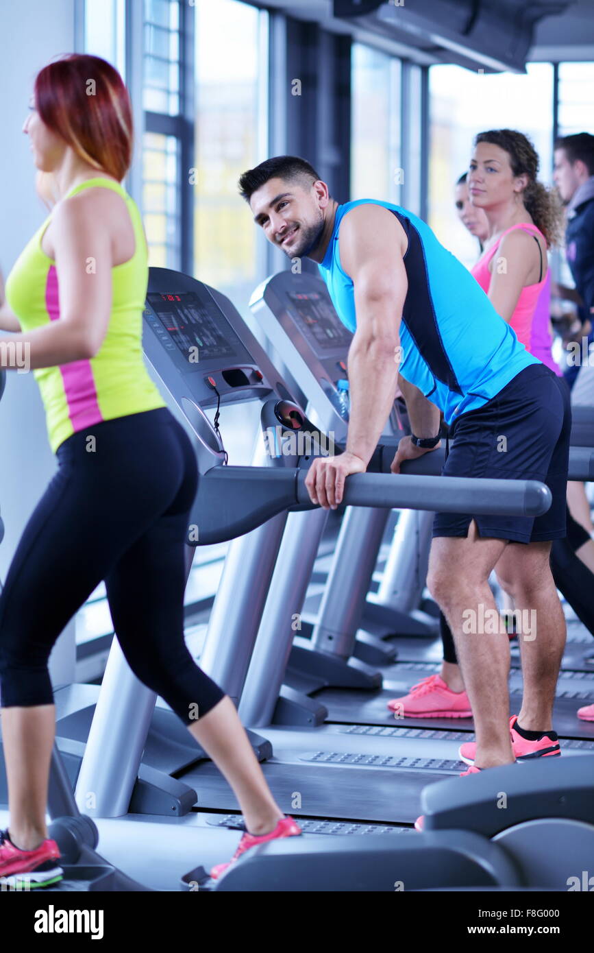 group of young people running on treadmills in modern sport gym Stock ...