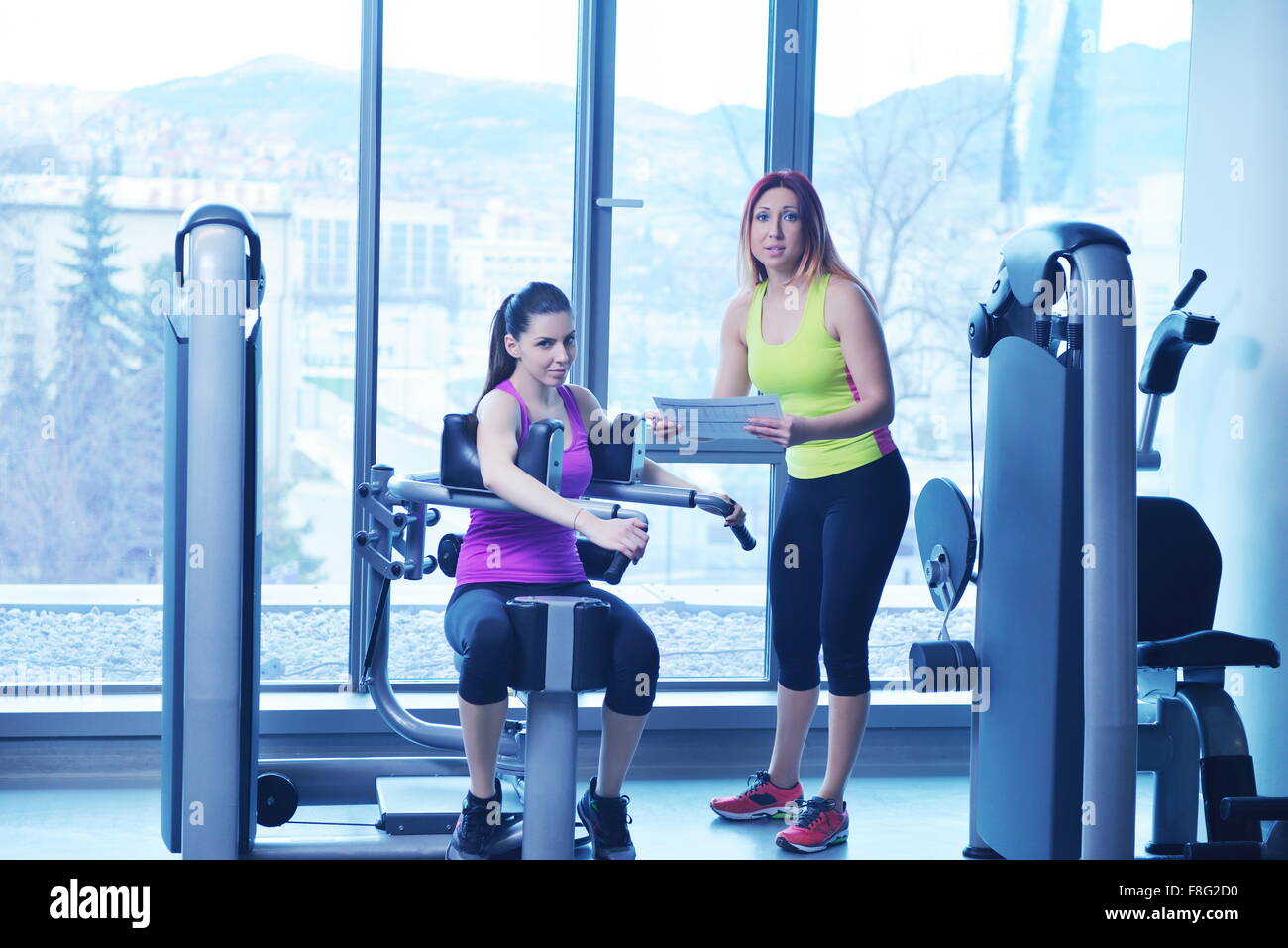 Gym woman exercising with her personal trainer Stock Photo - Alamy