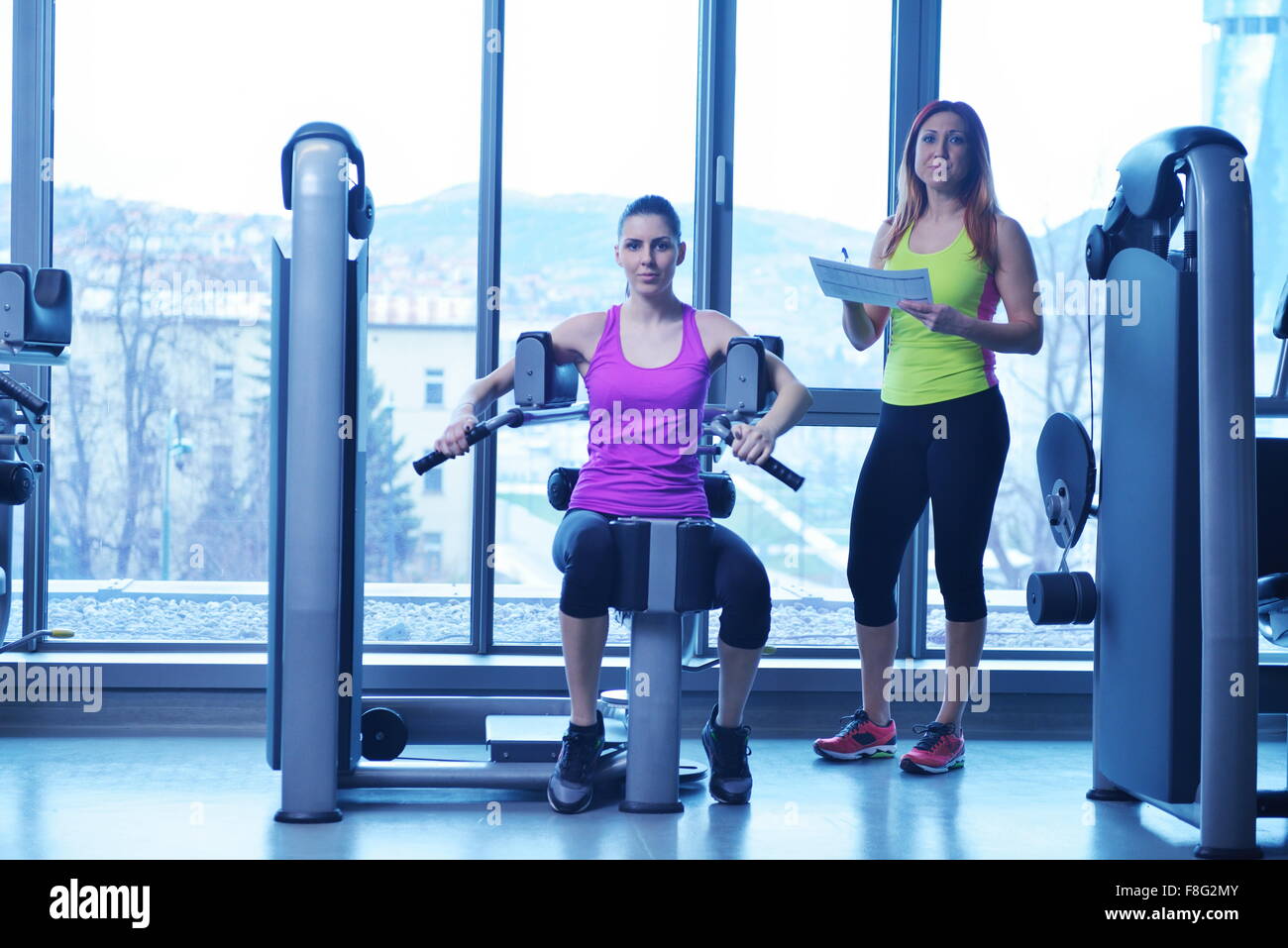 Gym woman exercising with her personal trainer Stock Photo - Alamy