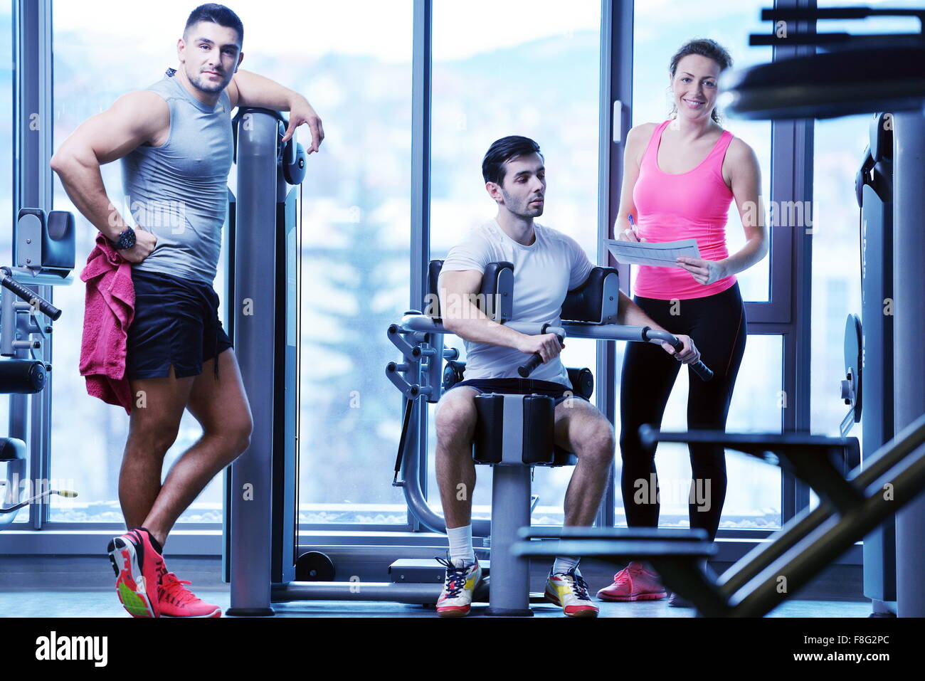 Gym woman exercising with her personal trainer Stock Photo - Alamy