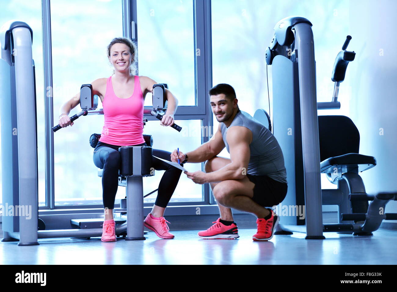 Gym woman exercising with her personal trainer Stock Photo - Alamy