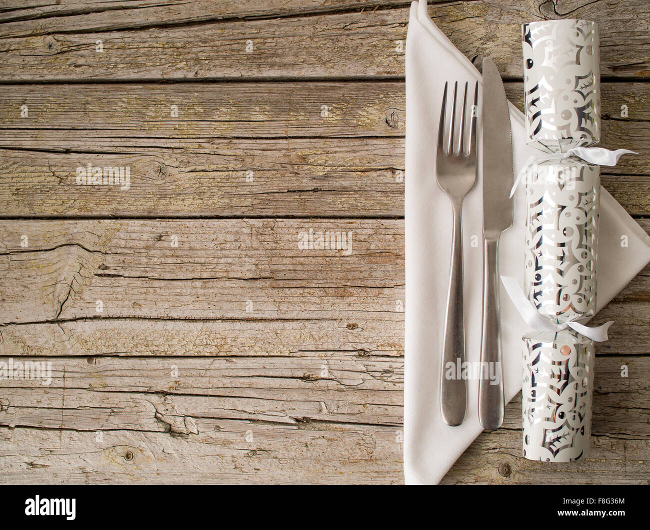 Christmas cracker and Cutlery kitchenware on old wooden boards background food concept Stock Photo