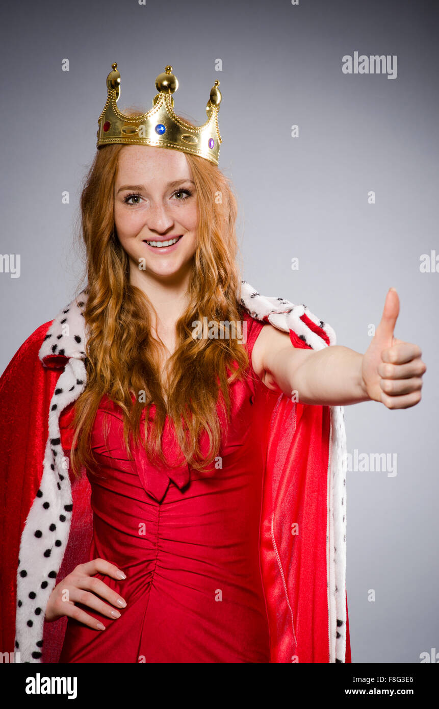 Queen in red dress in studio Stock Photo - Alamy