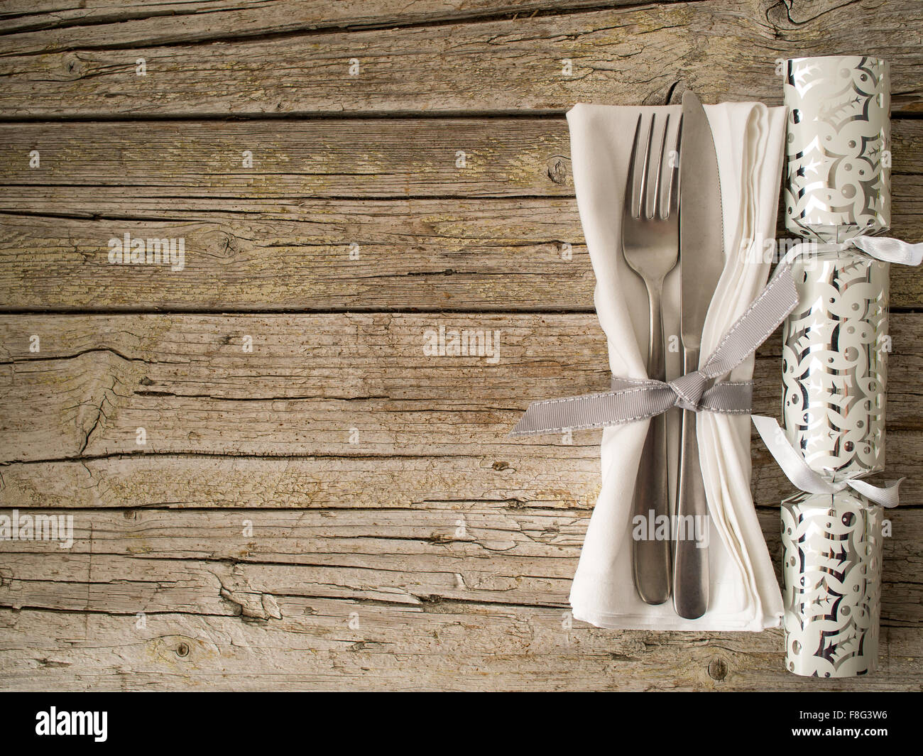Christmas cracker and Cutlery kitchenware on old wooden boards background food concept Stock Photo