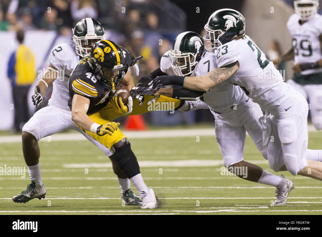 Indianapolis, Iowa, USA. 5th Dec, 2015. Michigan State Spartans cornerback Darian Hicks (2) Demetrious Cox and Chris Frey knock Iowa Hawkeyes tight end George Kittle (46) to the ground after his first down grab in the Big Ten Championship at Lucas Oil Stadium Between the Michigan State Spartans and the Iowa Hawkeyes in Indianapolis, In., Saturday, Dec. 5th, 2015. © Louis Brems/Quad-City Times/ZUMA Wire/Alamy Live News Stock Photo