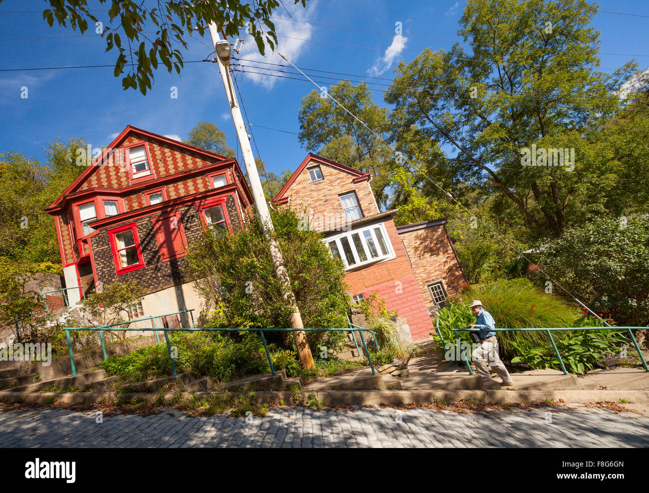 A man standing in front of two houses on Canton Avenue in the Beechview