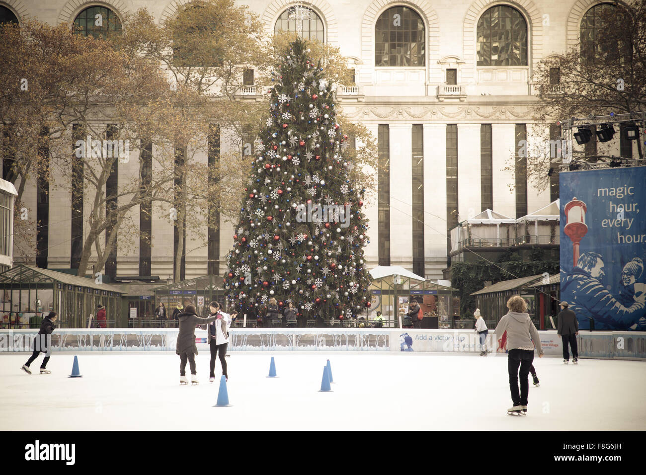 View of Citi Pond ice skating rink at Bryant Park in Manhattan with Christmas Tree on display Stock Photo